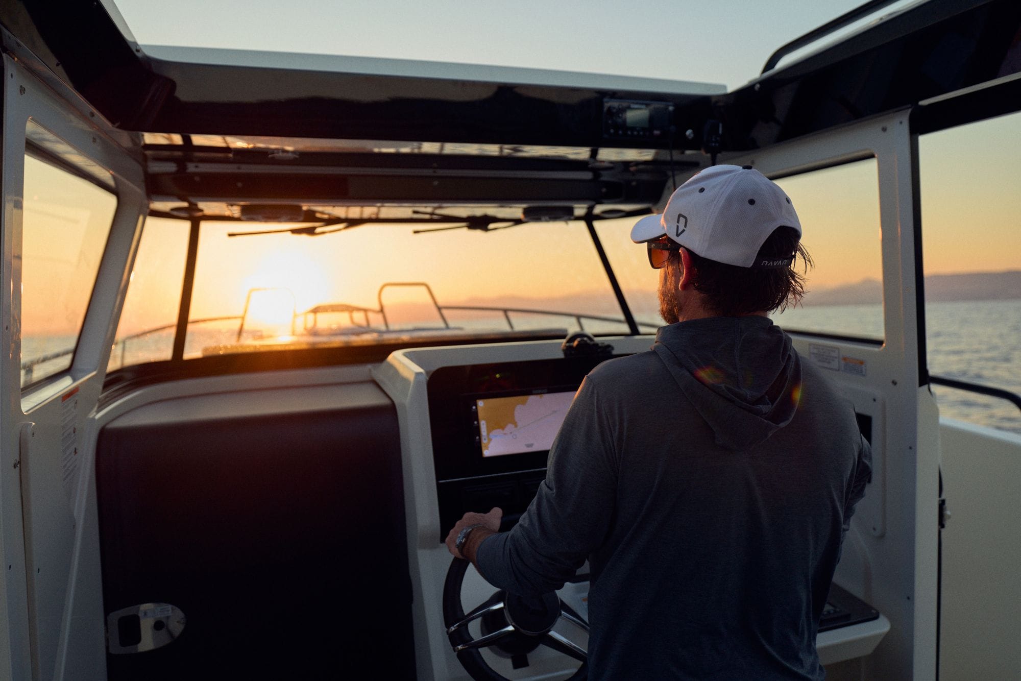 The skipper at the C38 helm at sunset