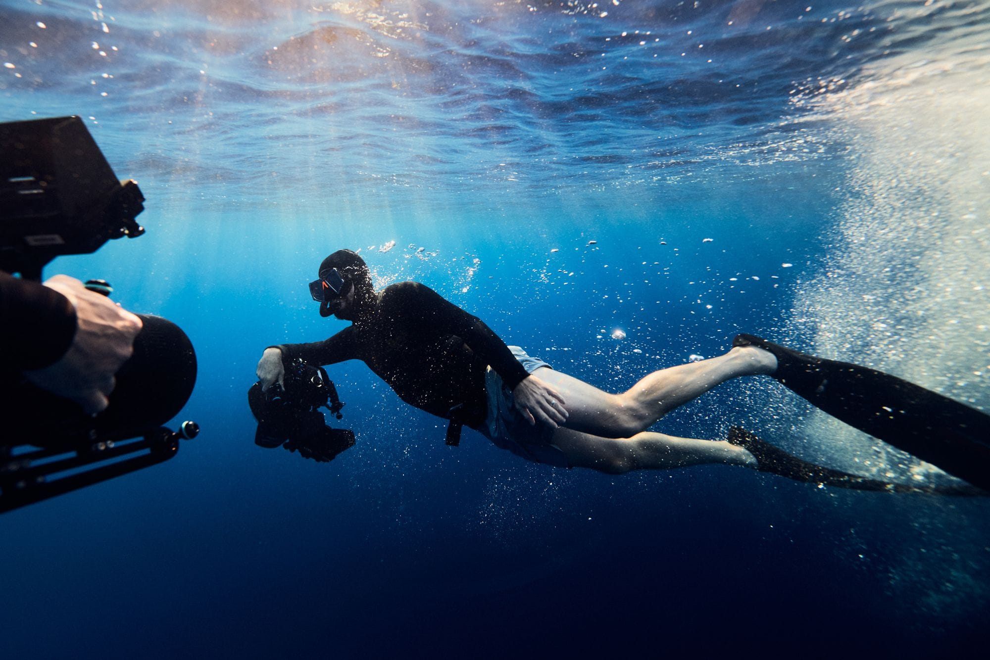 A freediver with a camera underwater