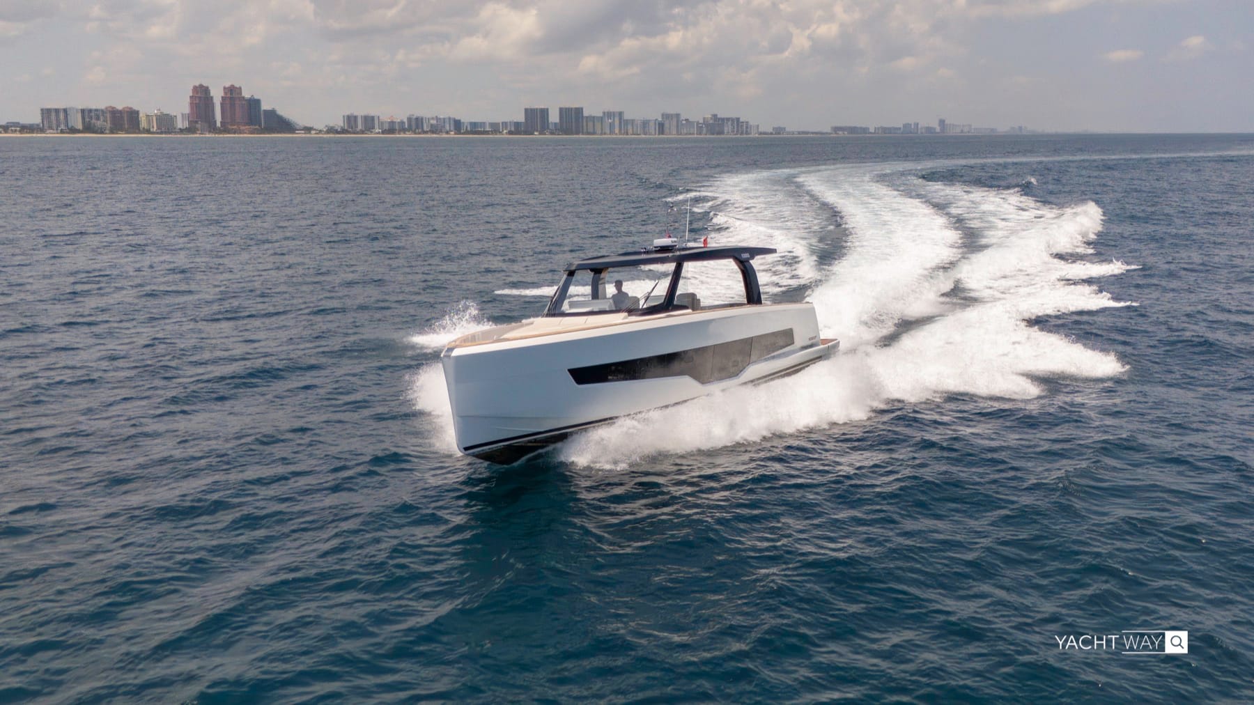 Fjord 53 XL running toward the camera with the South Florida skyline behind