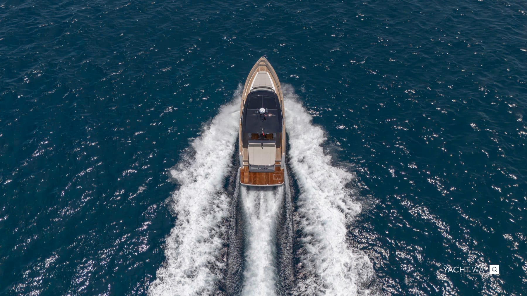 Overhead view of a Fjord 53 XL running at speed with a white wake