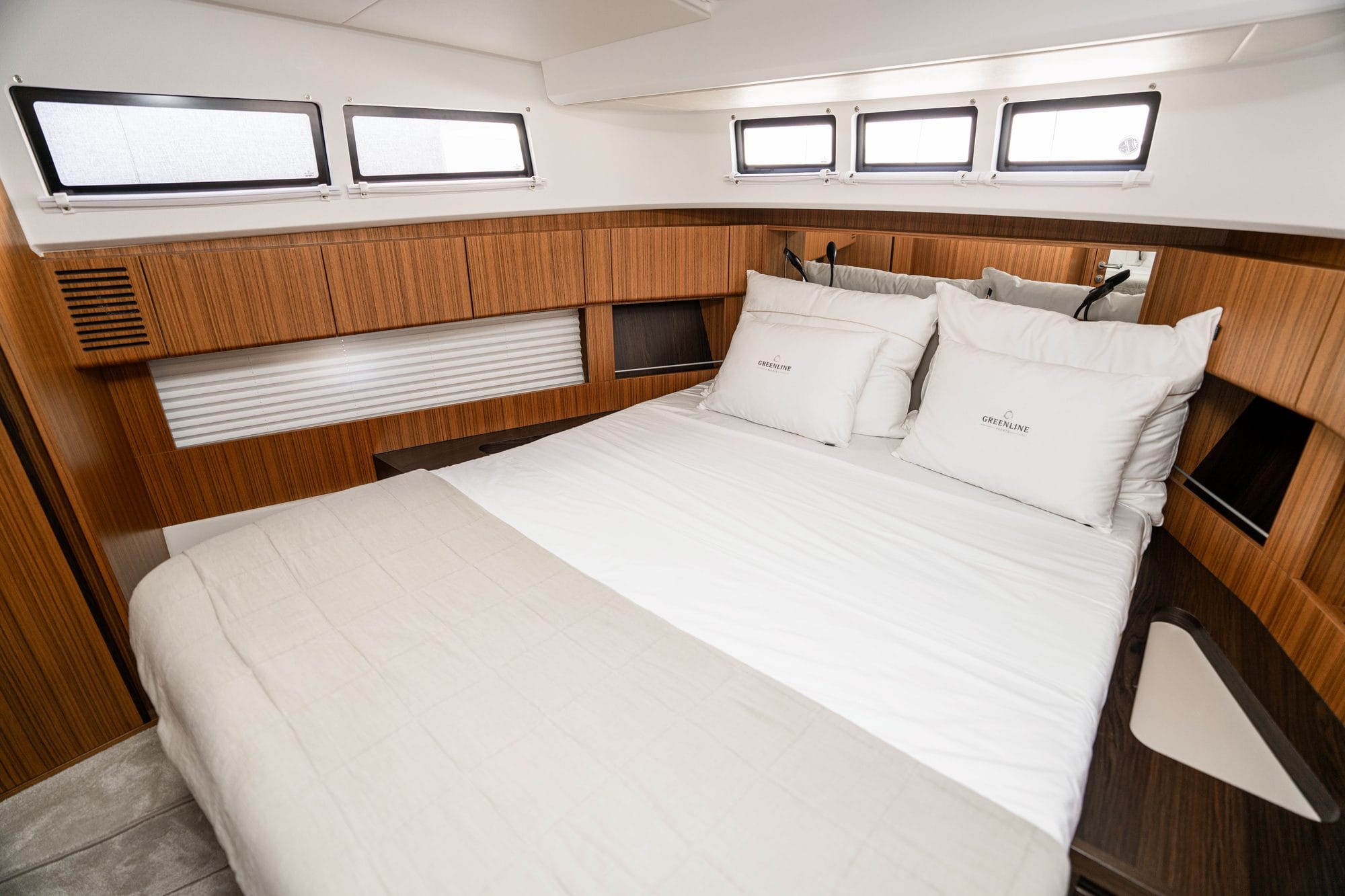 Owner's cabin with a double bed and long hull windows