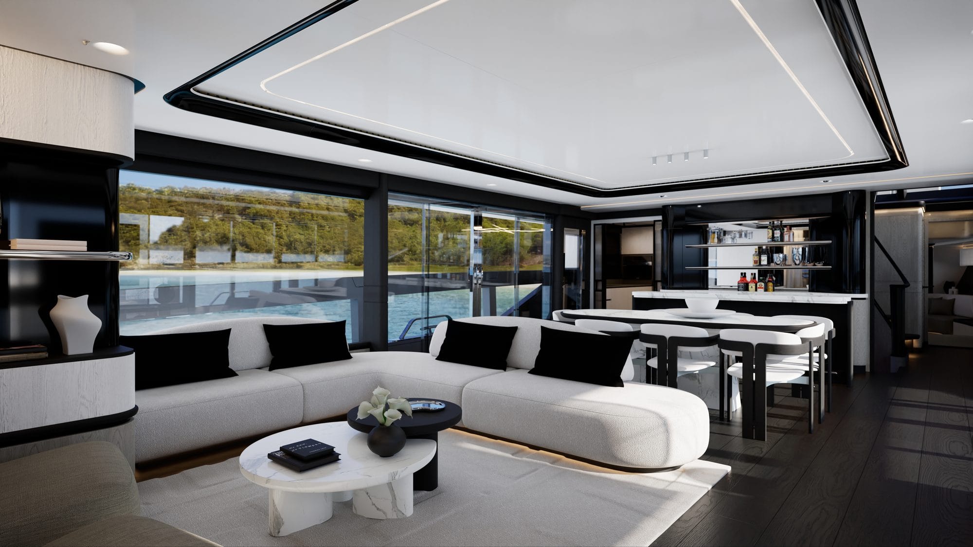 Main-deck saloon in black and white with a curved sofa and dining table
