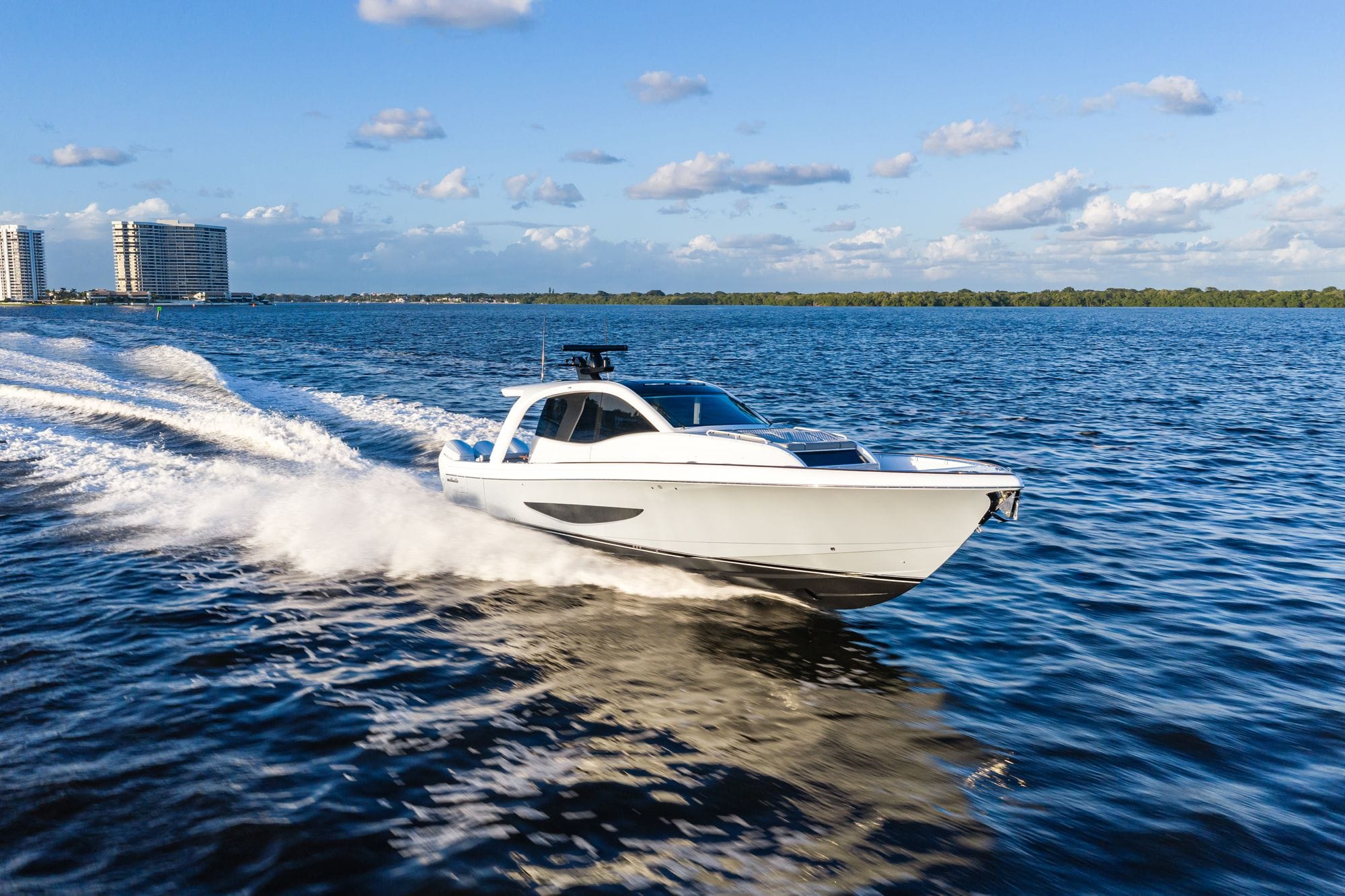 The Valhalla 46 Sport Yacht running past a city skyline