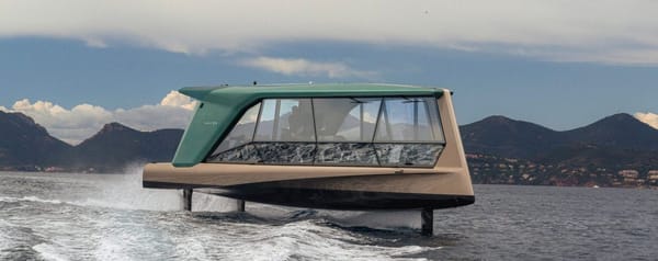 "BMW's 'The Icon' electric yacht anchored at Cannes, showcasing its sleek design against the backdrop of the Cannes shoreline